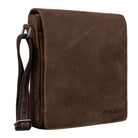 Small brown leather messenger bag in portrait format with shoulder strap side view