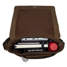 Open brown leather messenger bag from above with filled compartments